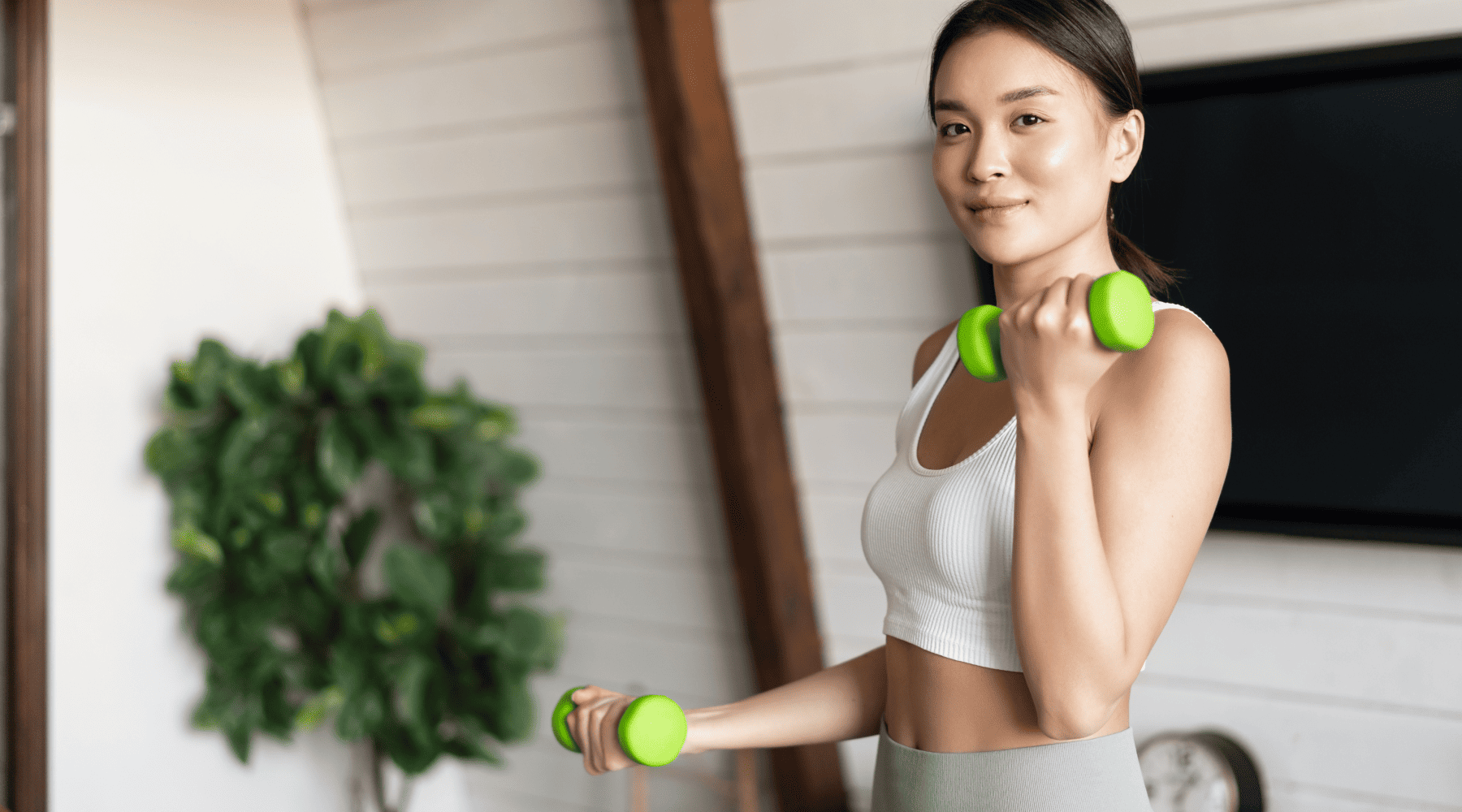 girl lifting green dumbbells