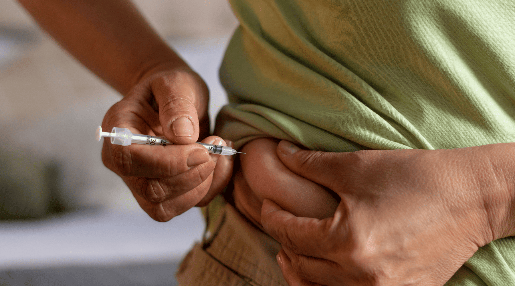 someone injecting GLP-1 medication into belly